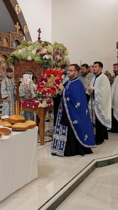 Orthodox clergy in blue and white vestments during a religious ceremony.