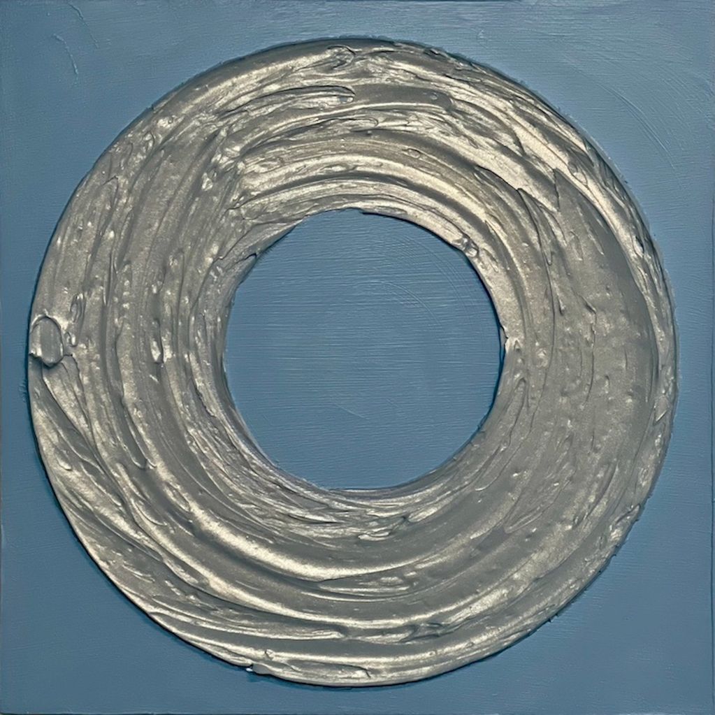 Silver textured circular design on a blue background.