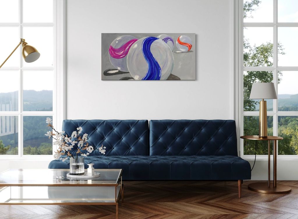Modern living room with navy sofa and marble-themed artwork.