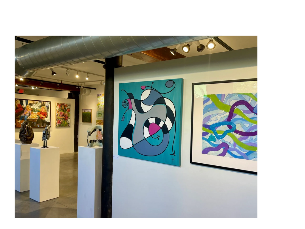 A modern art gallery showcasing abstract paintings and sculptures on white pedestals.