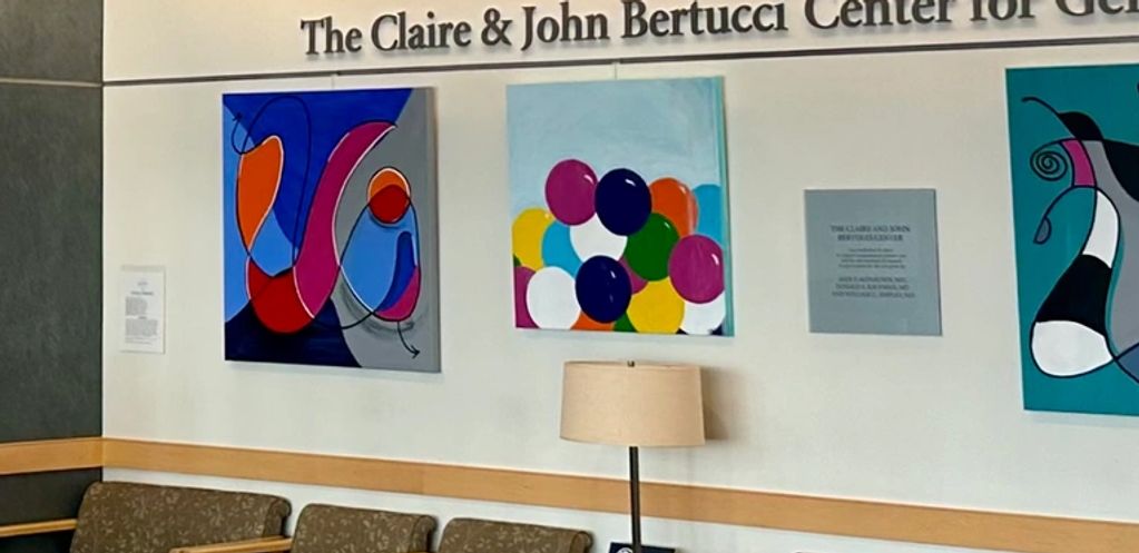Waiting area at The Claire & John Bertucci Center for Genitourinary Cancers with colorful abstract art.