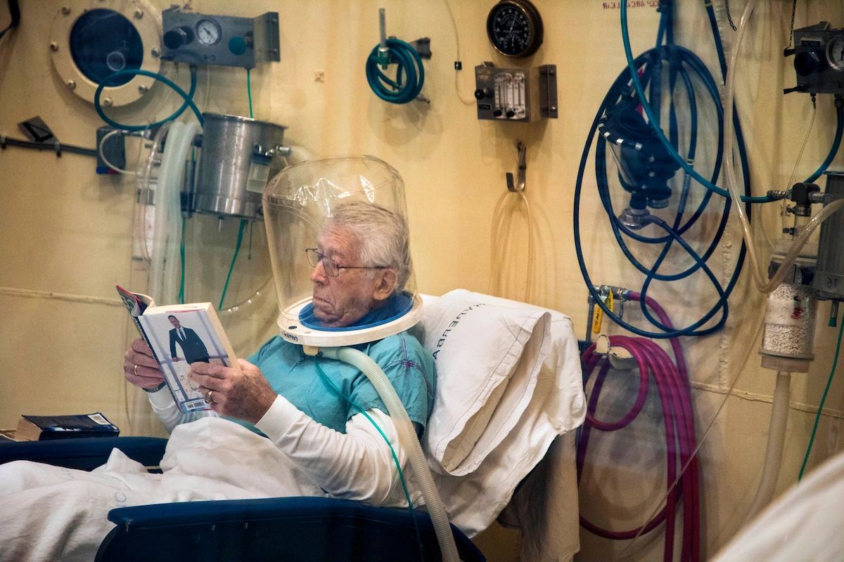 A patient (not Robert Russell) at Duke Clinics is treated in a hyperbaric chamber, like Russell was. Kevin Kraft, RN, nurse manager there, said that about 75 percent of patients treated in the unit at Duke Clinics are patients who had cancer, who received radiation to cure their cancer, but who later suffered negative side-effects of their radiation treatments. (photo by Shawn Rocco)