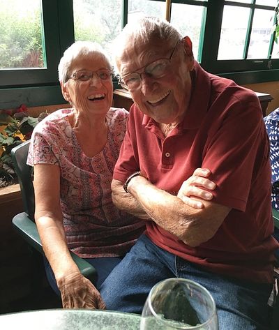 Elder couple smiling wearing spectacles