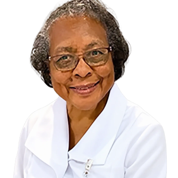 Smiling elderly woman wearing glasses and white uniform.