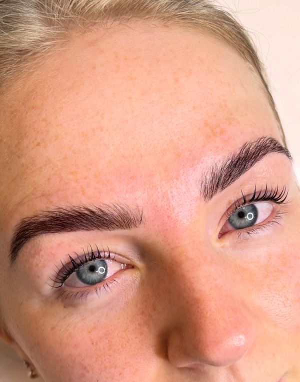Close-up of eyebrows and blue eyes.
