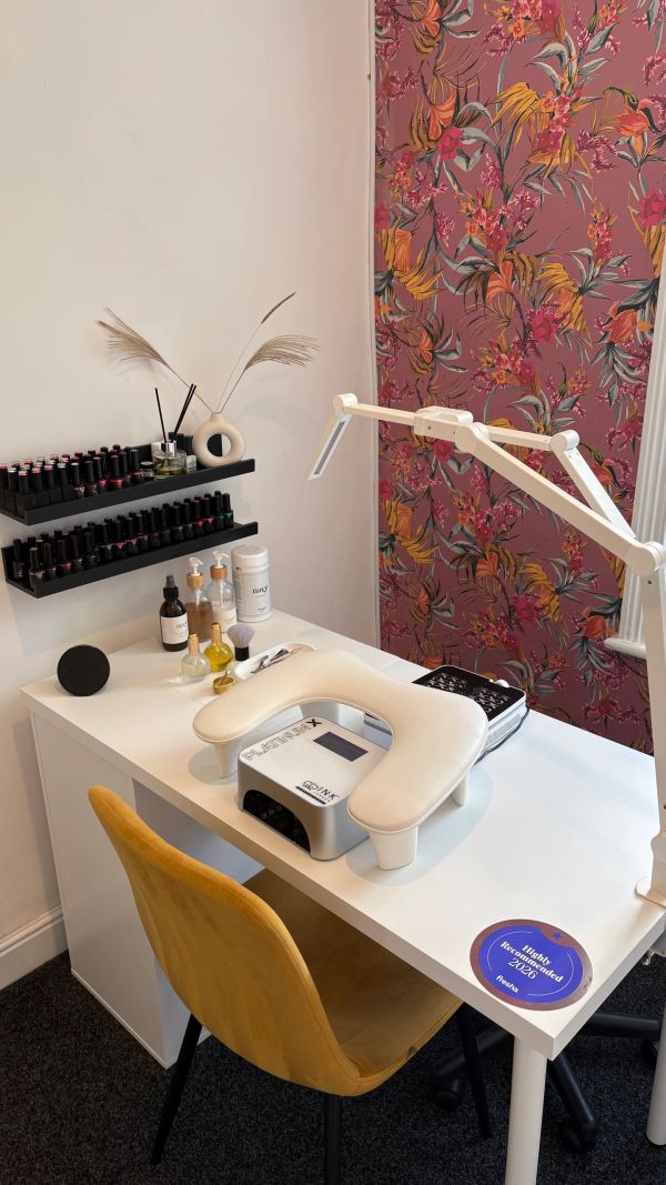 A cozy nail salon setup with nail polish and ergonomic chair.