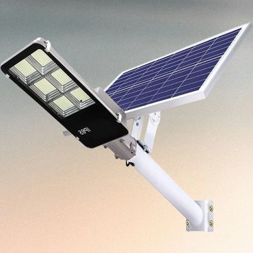 Solar-powered LED street light mounted on a white pole.