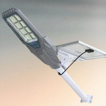 Modern solar-powered street light with LED panels and solar panel attachment.