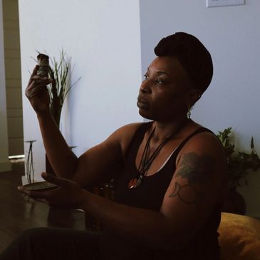 Woman examining an object closely in a calm indoor setting.
