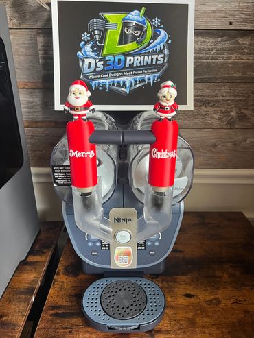 Christmas-themed Ninja coffee maker with Santa and Mrs. Claus handles.