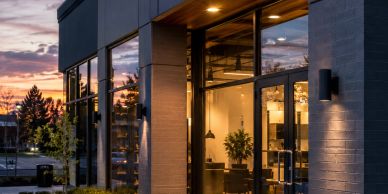 Modern commercial building entrance at sunset.