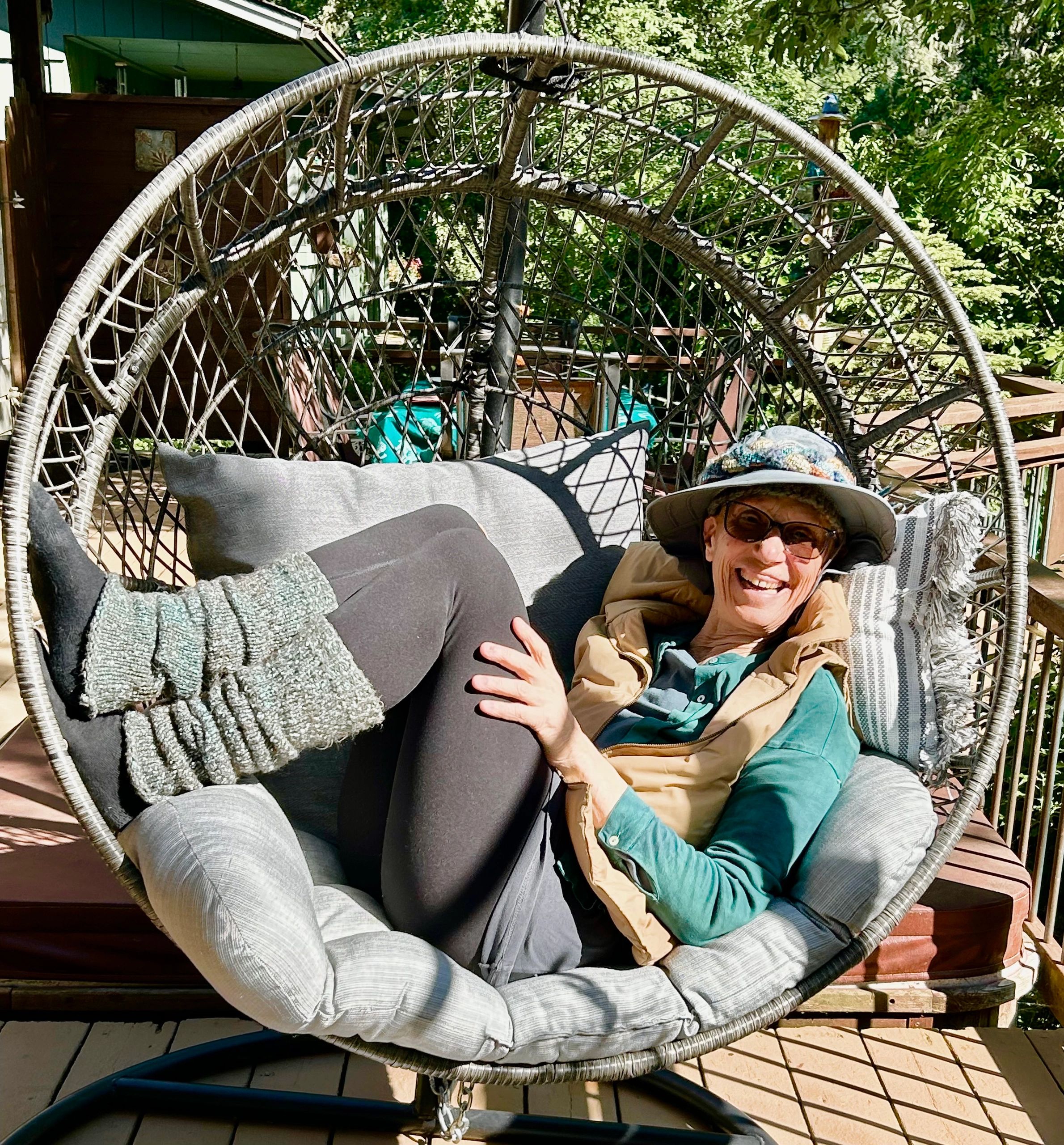 A circular design with moon phases, sun, mountains, hands shaking, and a tree.