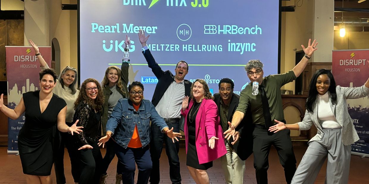 A joyful group poses energetically at a DHR HTX 3.0 event in Houston.