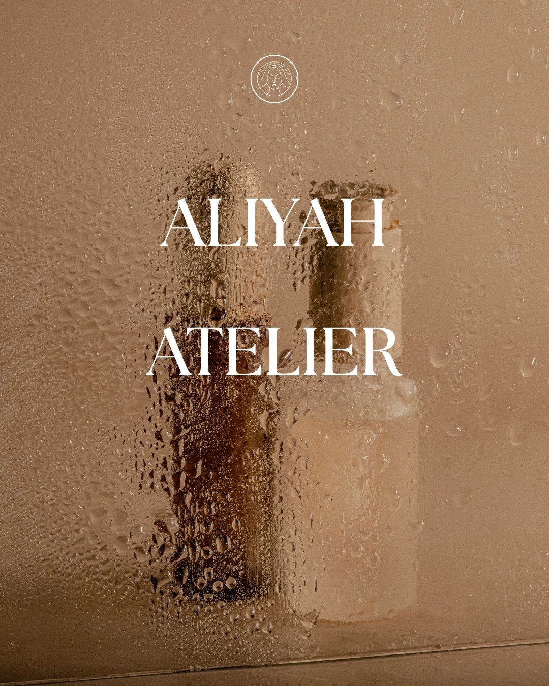 Aesthetic image of bottles behind a water-droplet covered glass with 'Aliyah Atelier' text.