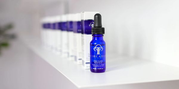 Blue Circadia Cyto-Comm facial serum bottle with boxes in the background.
