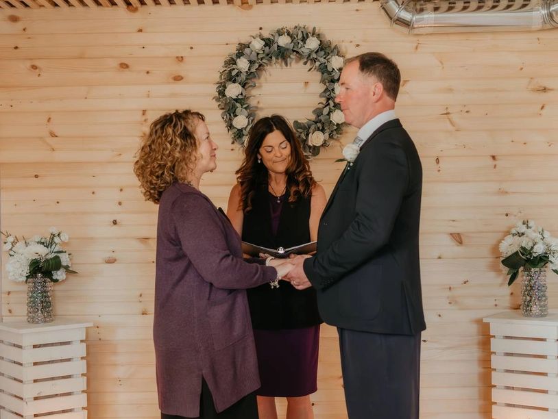 Couple exchanging vows during a wedding ceremony indoors.