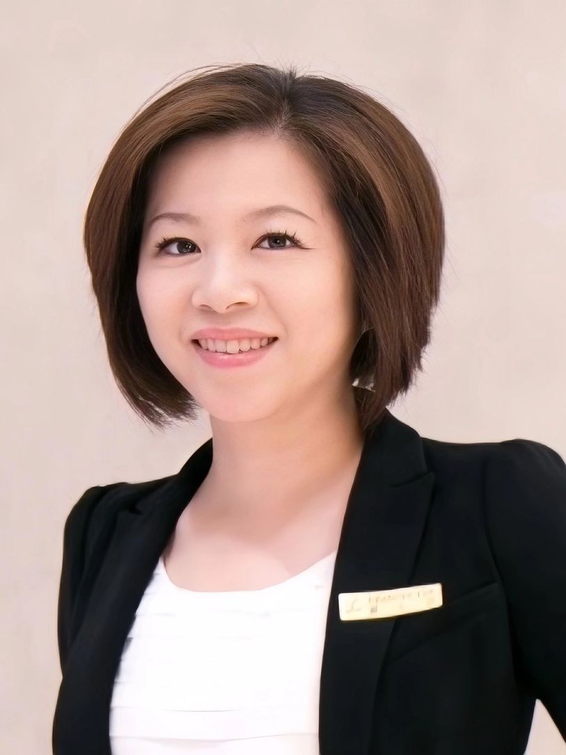 Professional woman smiling confidently in a black blazer.