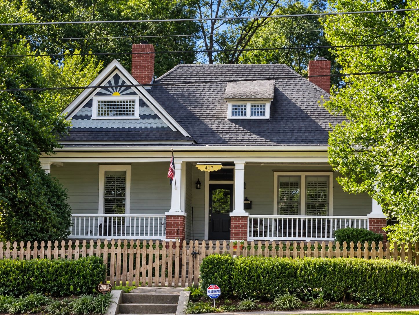 Charming house with a picket fence and greenery.