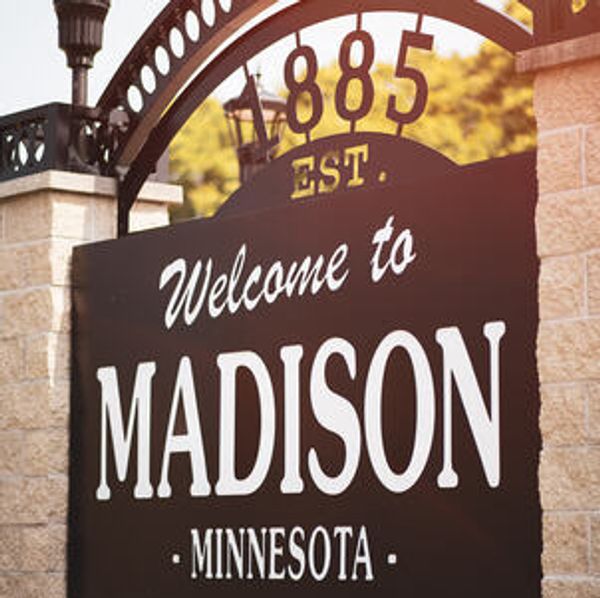 Welcome sign for Madison, Minnesota, established in 1885.