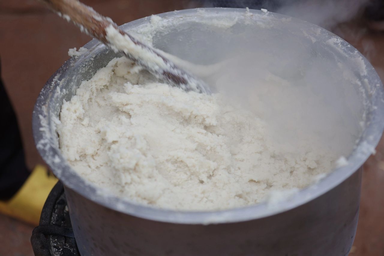 Ugali being pounded and molded