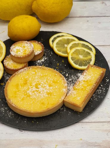 An image showing a selection of Lemon Citron tarts dusted in sugar powder