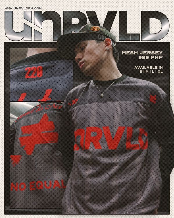Young man modeling gray and red mesh jersey from UNRVLD.