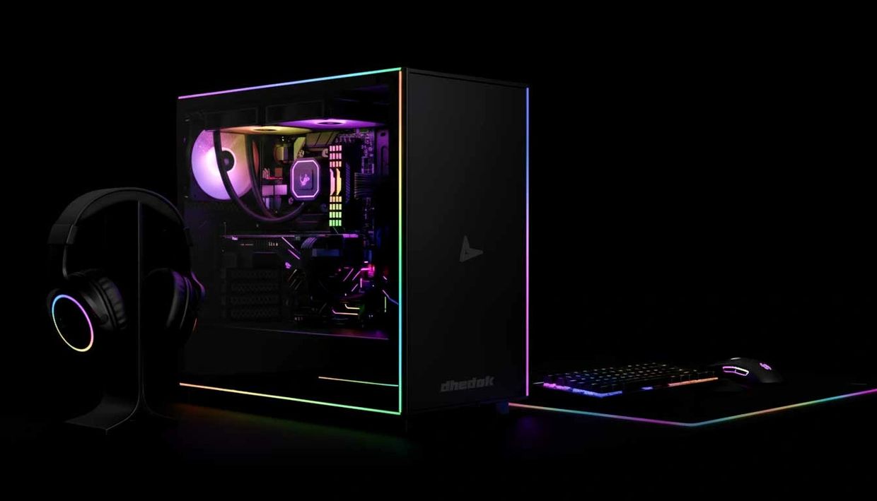RGB-lit gaming PC setup with headset, keyboard, and mouse on a dark background.