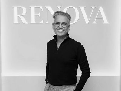 Man smiling in front of a RENOVA sign.