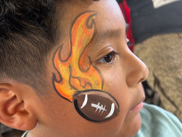 Boy with flaming football face paint.