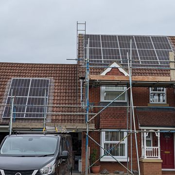 Solar arrays split over two roof elevations. Scaffolding to both areas