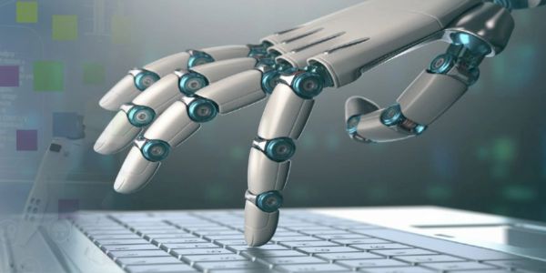 A robotic hand typing on a keyboard.