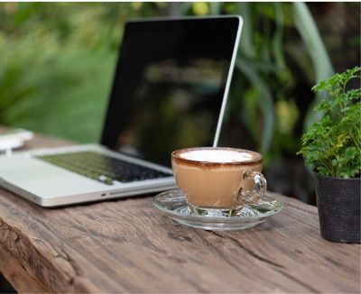 image of  computer and a coffee in the garden