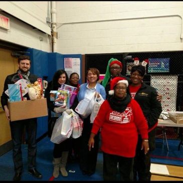 Group of people holding gifts at a festive event.