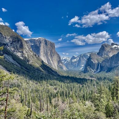 Snow lingers on the top of El Capitan and Half Dome in Yosemite valley.