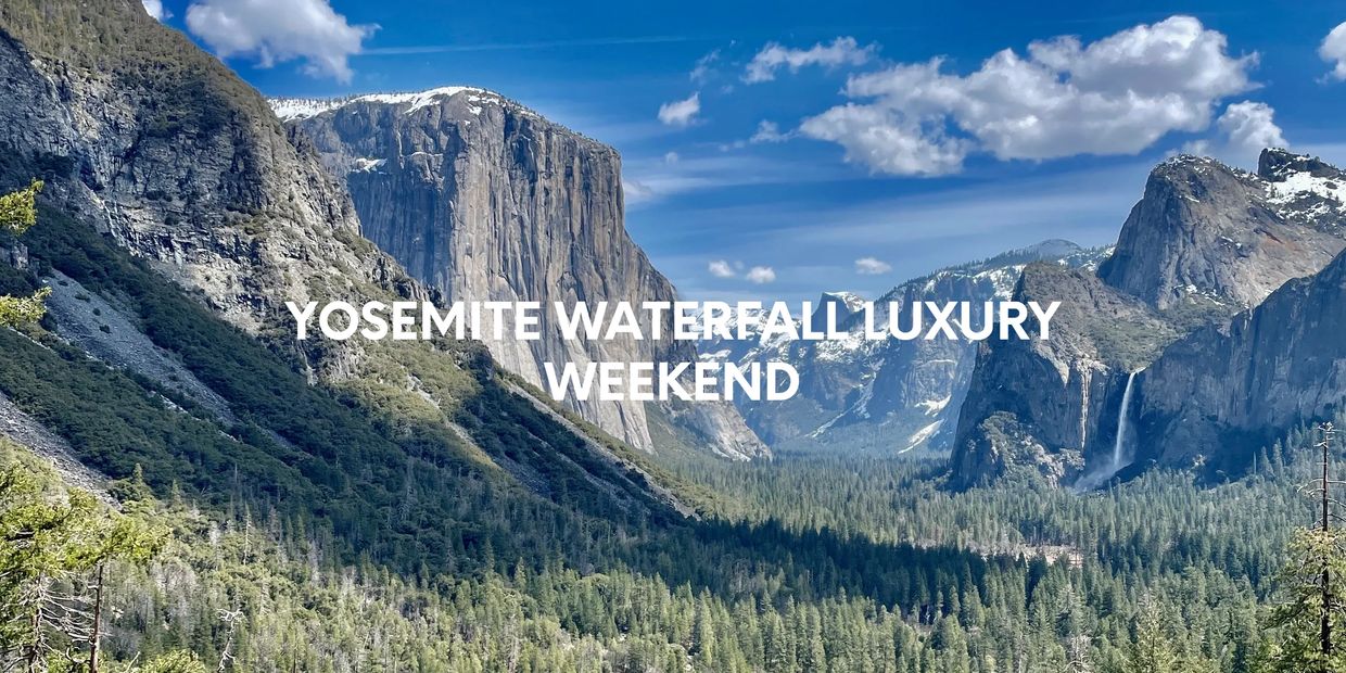 Yosemite Valley with snow capped peaks and a flowing Bridalveil falls.