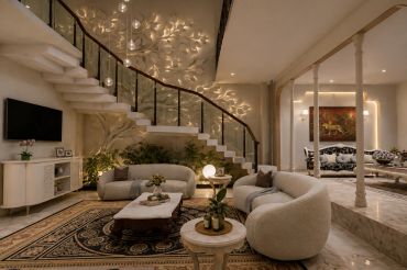 Modern living room with curved staircase and warm lighting.