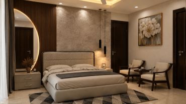 Luxury bedroom interior in Gurgaon with an upholstered bed, textured feature wall, pendant lighting and a cosy seating area.