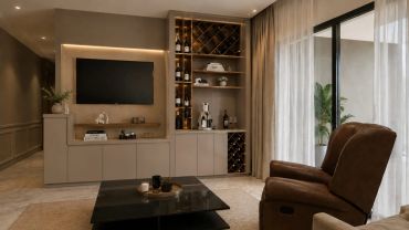 Modern living room with TV, wine storage, and cozy recliner.