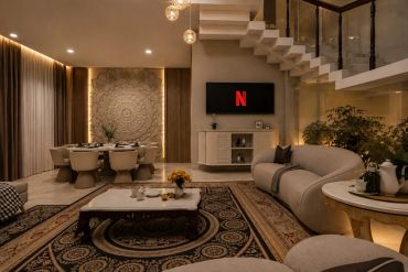 Elegant living room with modern furniture and warm lighting.
