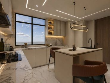 Modern kitchen with marble surfaces and warm lighting.