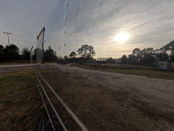 Close-up Airstream Polishing with high-gloss aluminum refinement and preservation.