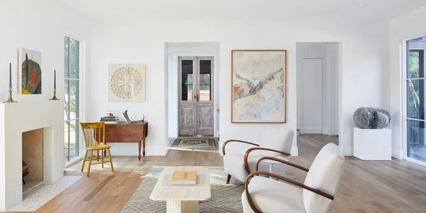 Bright, minimalist living room with modern furniture and art.