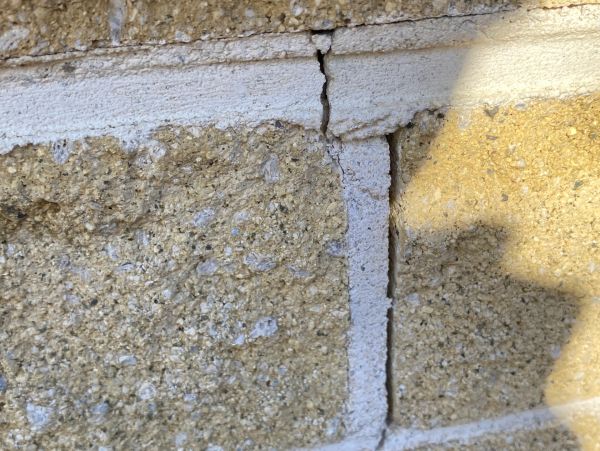 Cracked concrete wall with textured surface.