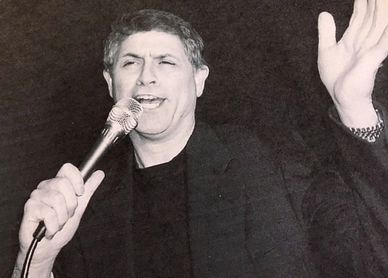 black & white photo of Jack Petrotto performing a song
