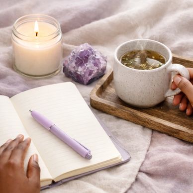 journal, candle with amethyst symbolic of client's spiritual healing journey with MariannePatricia.