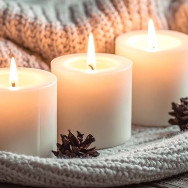 3 lit candles symbolic of client feeling empowered and at peace throughout soul-mind-body.