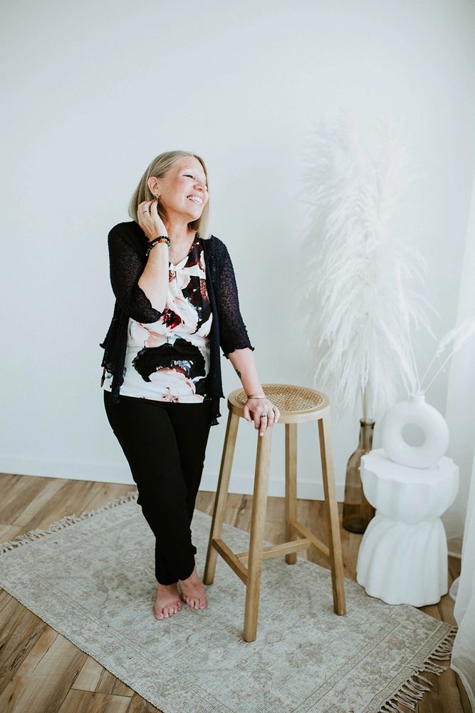 Empowered woman 40+ feeling joy & spiritual wellness after emotional trauma healing & life coaching