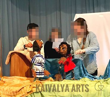 three students with puppets