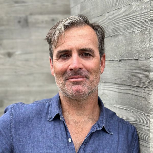 RobbieLee in front of an off form board form concrete wall