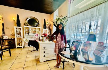 Skyler Farasat with her books that are available for purchase at The Hidden Tea Room in Lodi CA 